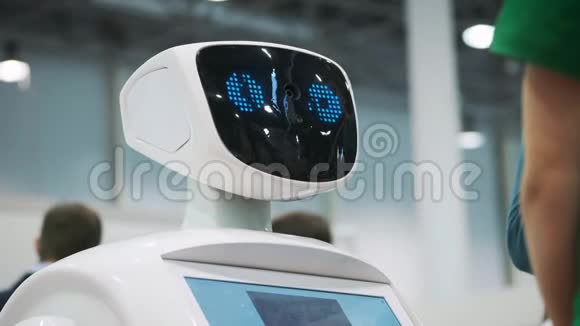 一个白色机器人在一个新技术的展览上与一个小学生互动这孩子熟悉视频的预览图