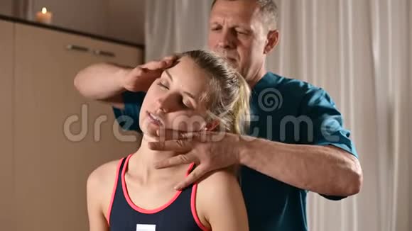 男性手动内脏治疗师按摩师治疗年轻女性患者编辑颈部和椎骨视频的预览图