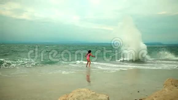 女孩面对沉重的大海试图避免海浪的喷射视频的预览图