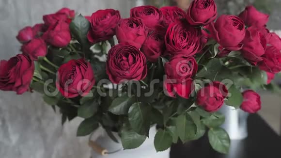 合上盛开的红玫瑰鲜花店车间花卉手工制作和艺术品概念视频的预览图