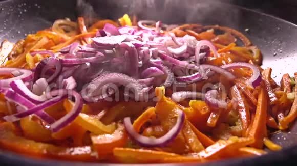 把切好的蔬菜混合在煎锅里在家做饭慢动作特写镜头视频的预览图