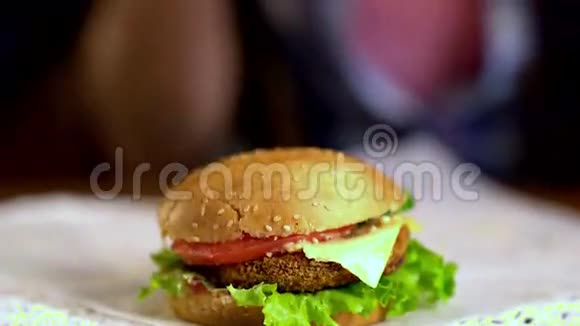 女人的手被放在桌上的汉堡包上4k视频的预览图