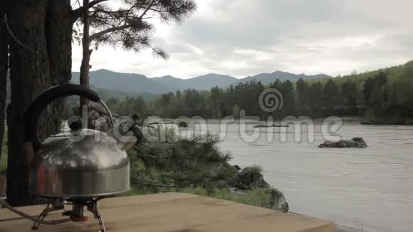 水壶在河底的煤气灶上沸腾视频的预览图
