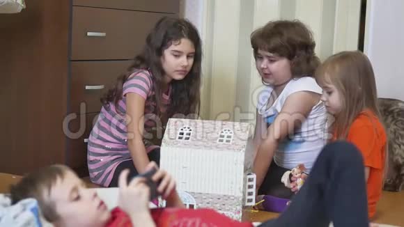 可爱的小女孩在玩玩具孩子们用手做了室内的纸盒娃娃视频的预览图