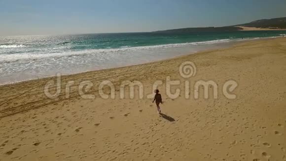 女人在荒无人烟的热带海滩散步视频的预览图