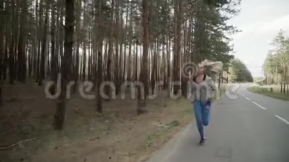 那个女孩在松树林里沿着马路跑视频的预览图