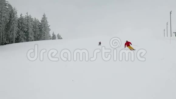 多云的冬天五彩缤纷的滑雪者一边滑雪一边享受视频的预览图