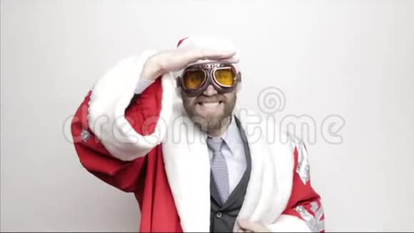 穿着圣诞老人服装的商人微笑着跳着滑稽的舞蹈看着远处视频的预览图