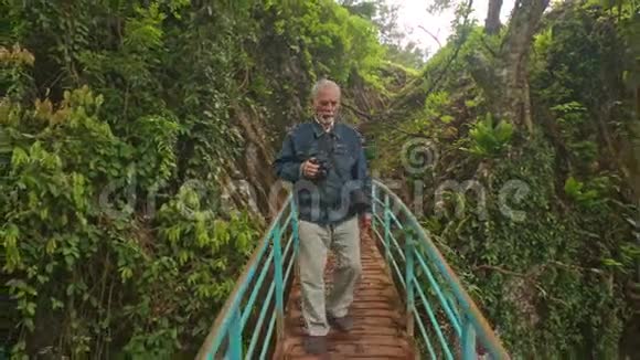 男子站在小木桥上照片景观公园视频的预览图