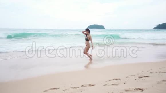 漂亮女孩穿着比基尼在海滩上奔跑视频的预览图