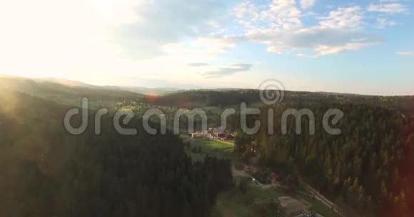 阳光明媚的一天在一个丘陵森林山谷空中景观视频的预览图
