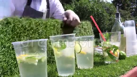酒保做莫吉托鸡尾酒酒保拔出并在莫吉托加冰视频的预览图