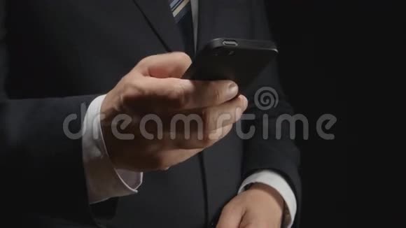 商人手拿智能手机手机上的类型侧视视频的预览图