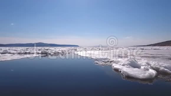 一架无人机飞过结冰的河流水和冰在结冰的河流上视频的预览图