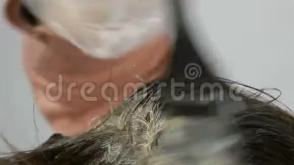 女性根上的白发这种头发本身就是用特殊的油漆和刷子在家里染发的视频的预览图
