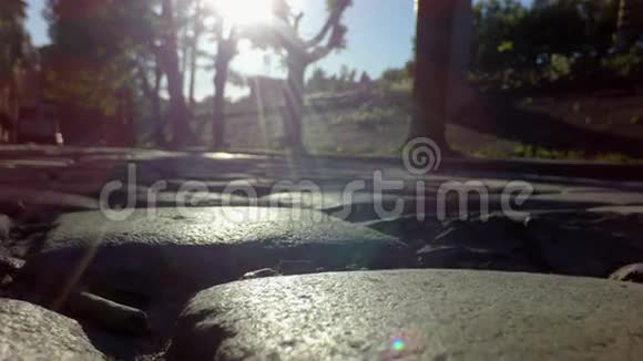 沿着鹅卵石铺成的道路向太阳倾斜视频的预览图