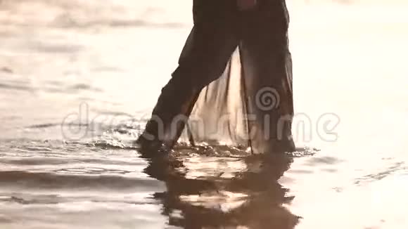 穿着黑色衣服的年轻女子在沙滩上下水视频的预览图