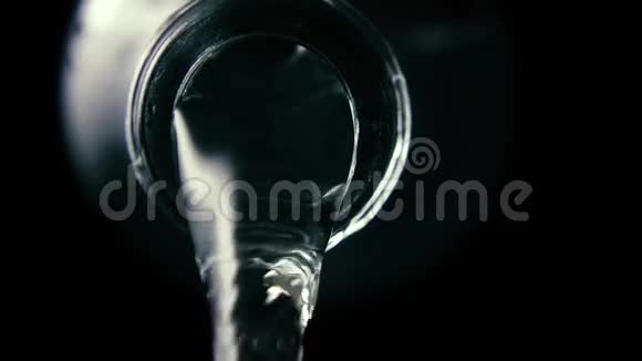 水是从玻璃瓶里倒出来的特写镜头黑色背景慢镜头视频的预览图