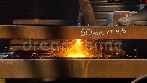 从侧面观察金属工业中使用气体火焰火炬切割金属的工人视频的预览图
