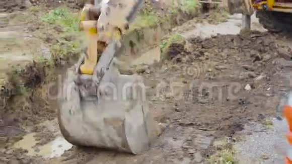 挖掘机铲斗夯实泥土建筑工地视频的预览图