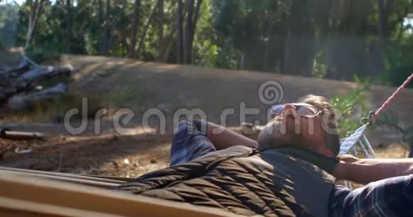 阳光明媚的一天男人在吊床上放松视频的预览图
