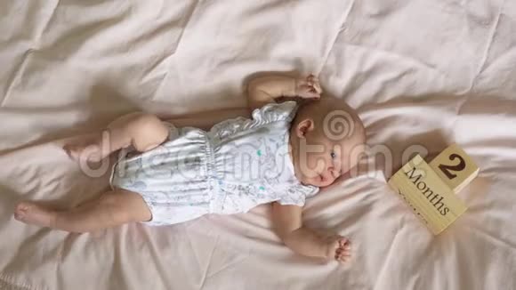 一个两个月大的婴儿躺在床上视频的预览图