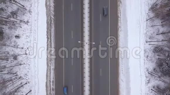 车辆通行冬季公路鸟瞰图在冬季道路上行驶的汽车和卡车视频的预览图