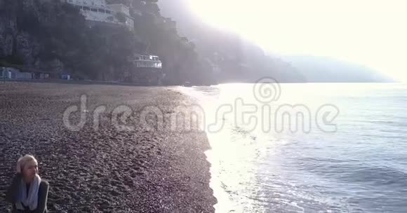 金发女人早上在海滩上放松意大利阿马尔菲海岸视频的预览图