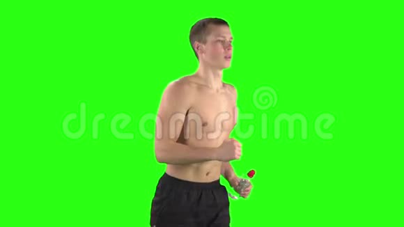 运动员在训练时穿短裤和一瓶水绿色屏幕慢动作视频的预览图