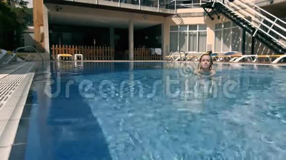 年轻漂亮的时尚运动女性在炎热的天气下在热带岛夏季在游泳池的比基尼户外摆姿势户外活动视频的预览图