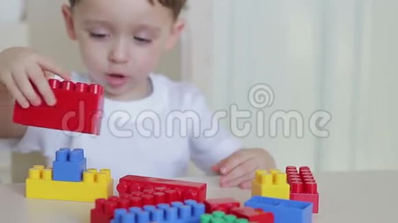 一个孩子在特写桌上玩彩色积木视频的预览图
