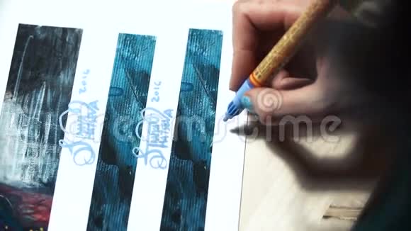 女艺术家在他的一些作品上签名一个大师的彩绘标志蓝色毛毡尖标记上的签名视频的预览图