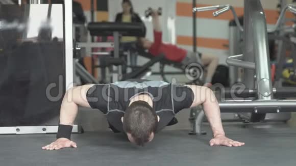 做俯卧撑的健身男子在健身房锻炼剧烈的训练视频的预览图
