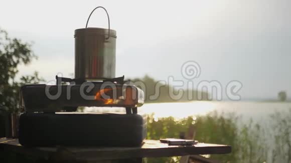 早上在煤气炉上煮靠近一个湖上面有美丽的阳光4K3840x2160高清高清视频的预览图