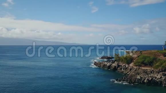 夏威夷毛伊岛上的蓝色海水和蓝天下的岩石海岸视频的预览图