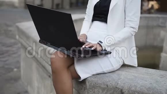 一个戴眼镜的年轻女商人在城里的电脑上工作视频的预览图