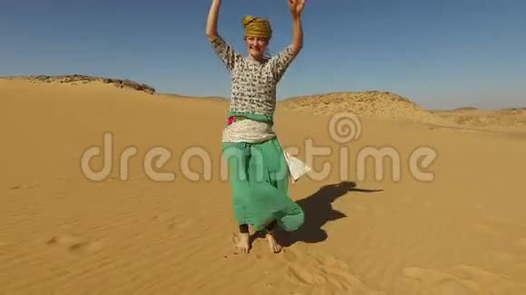 埃及沙漠中赤脚跳舞的快乐女人视频的预览图