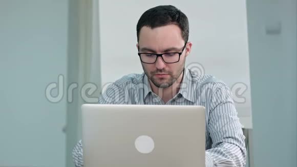 手提电脑上戴眼镜的帅哥老师视频的预览图