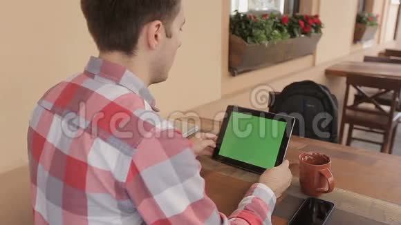 男士手持平板电脑触摸屏带有用于定制内容的绿屏色度键男士饮料可与绿屏搭配使用视频的预览图