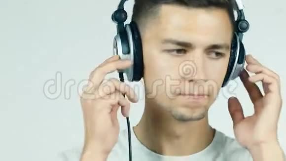 带着耳机在白色背景下听音乐的人视频的预览图