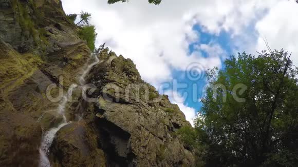 蓝色天空中的岩石中的漩涡瀑布白云背景时间流逝4K阿尔泰山视频的预览图