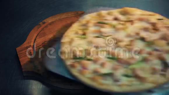 把披萨放在金属桌上的木盘上女人手把它拿走视频的预览图