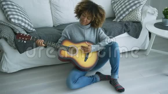 年轻女子在家弹吉他视频的预览图