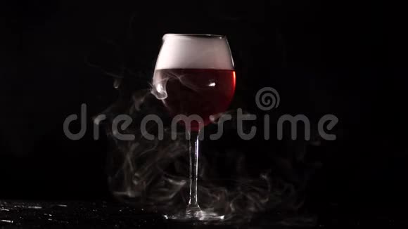 在黑色的背景上一杯红色的液体冒出蒸汽视频的预览图