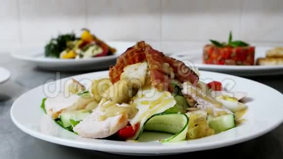凯撒色拉与鸡肉和培根片几个现成的食物在一个专业的餐厅厨房准备视频的预览图