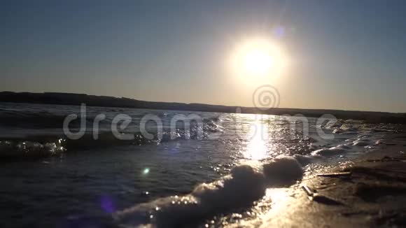 波浪在水面上泡沫在夕阳下慢动作视频的预览图