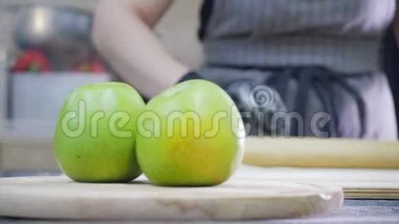 女人在商业厨房为苹果派准备面团视频的预览图