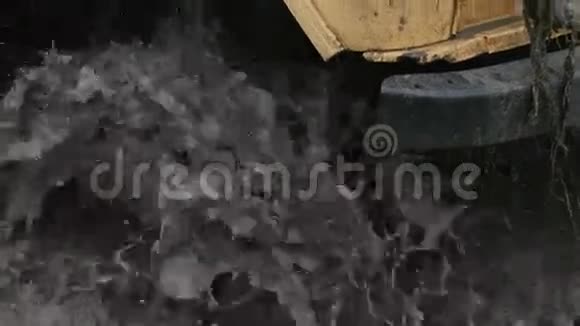 一个车轮卡在脏水和泥泞中的特写镜头轮子在转但它无能为力视频的预览图
