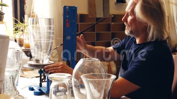 吹玻璃的人在玻璃花瓶上工作视频的预览图