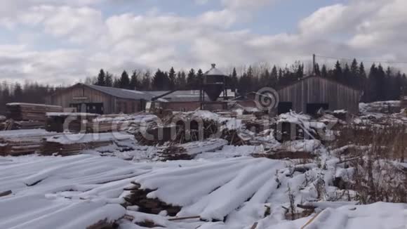 锯木厂的院子里存放着一堆堆覆盖着雪的木材材料视频的预览图